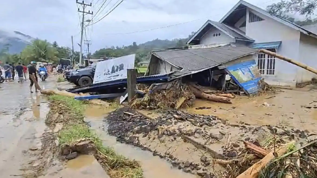 Floods and landslides in Indonesia leave at least 21 dead, dozens ...